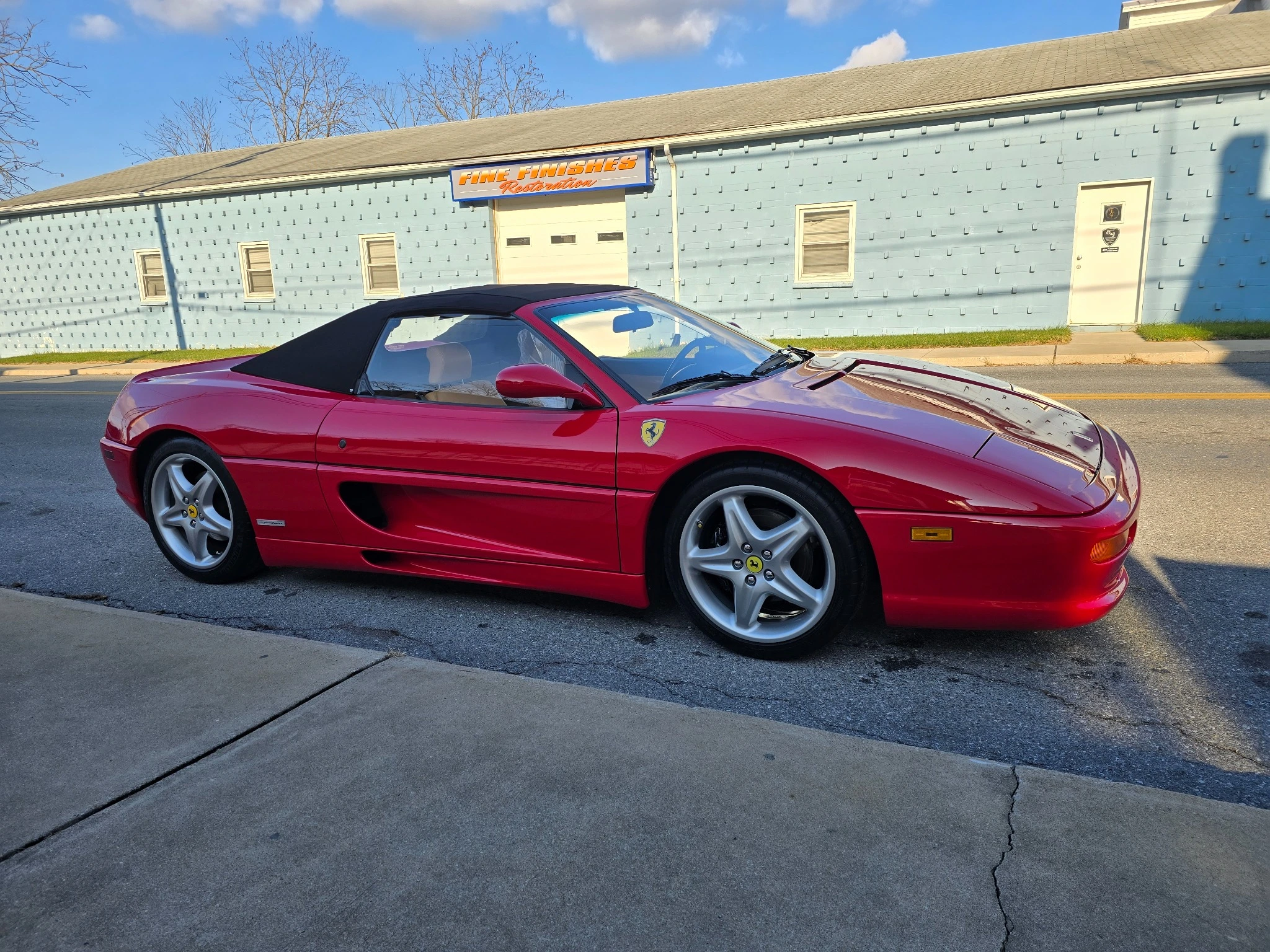Red Ferrari outside Fine Finishes Restoration
