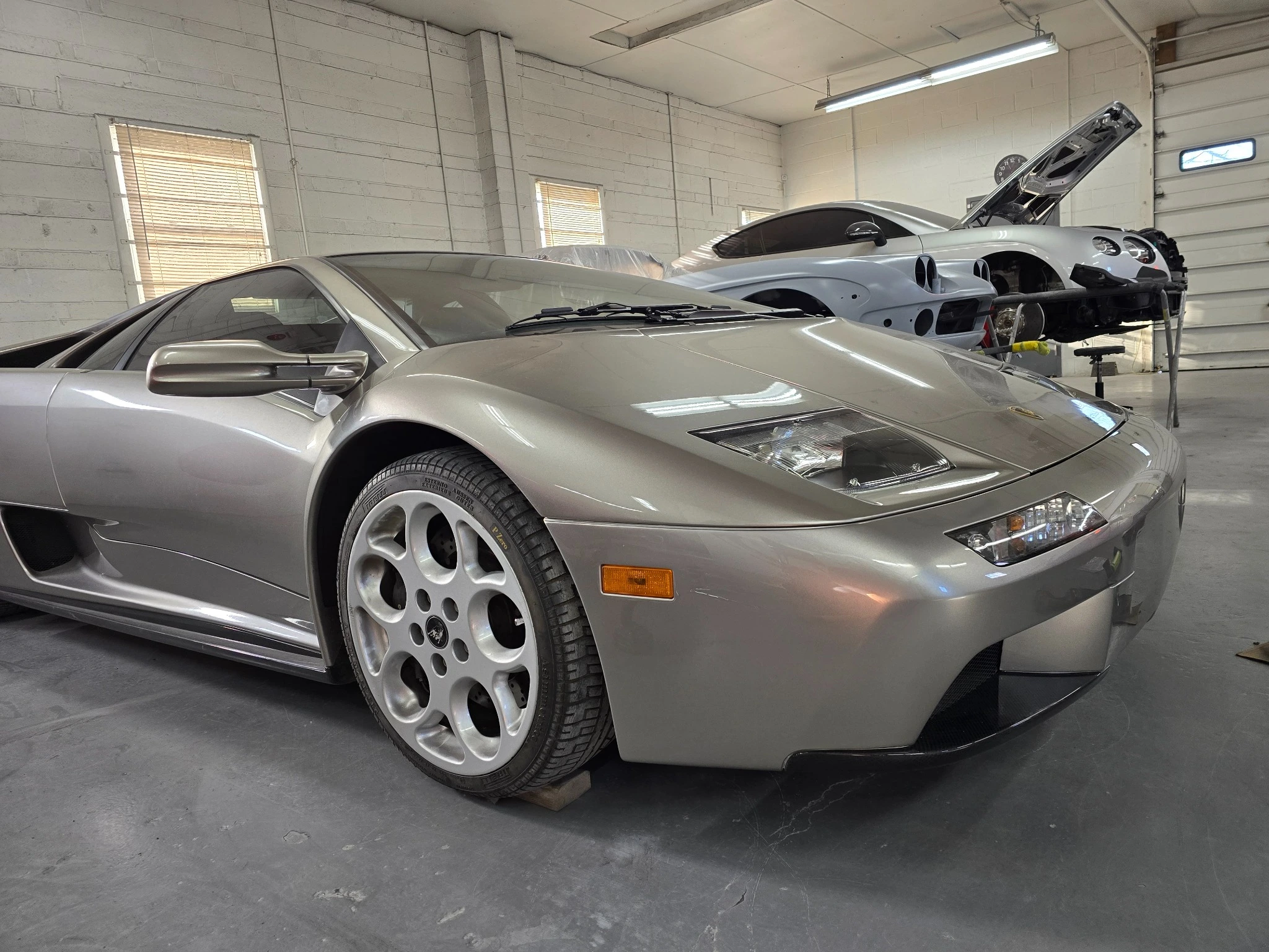 Gray Lamborghini in the Fine Finishes workshop