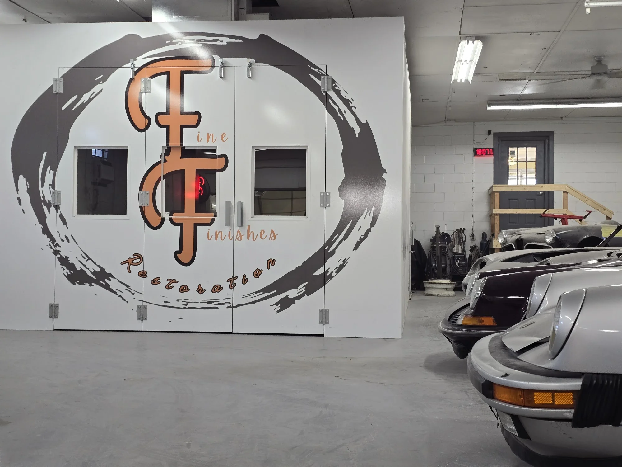 The Fine Finishes Restoration logo on the workshop wall